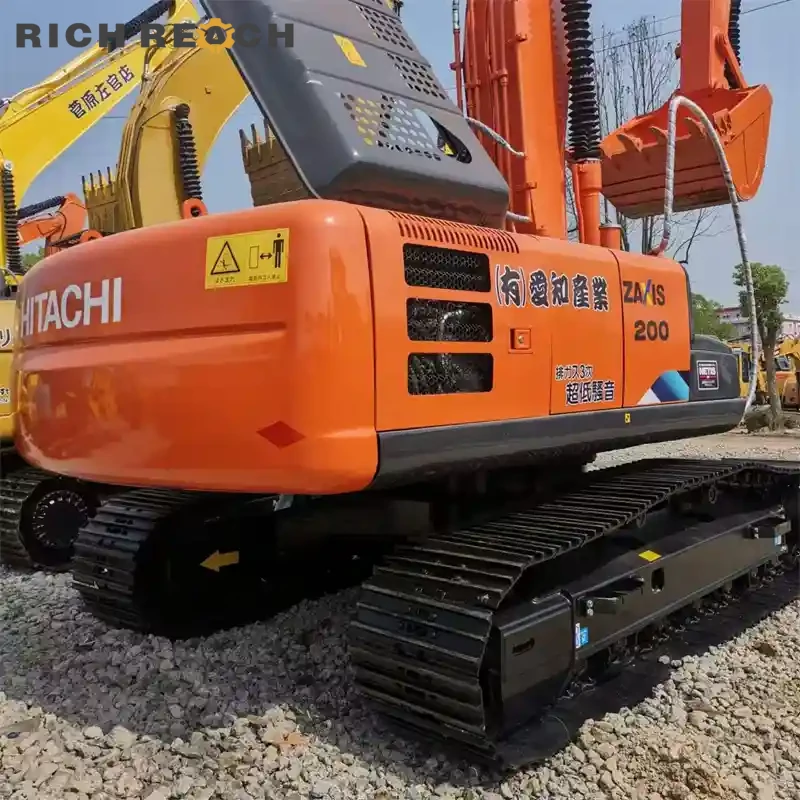 Used Hitachi ZAXIS 200 excavator – loading dump truck on site – productive cycle ready for job site