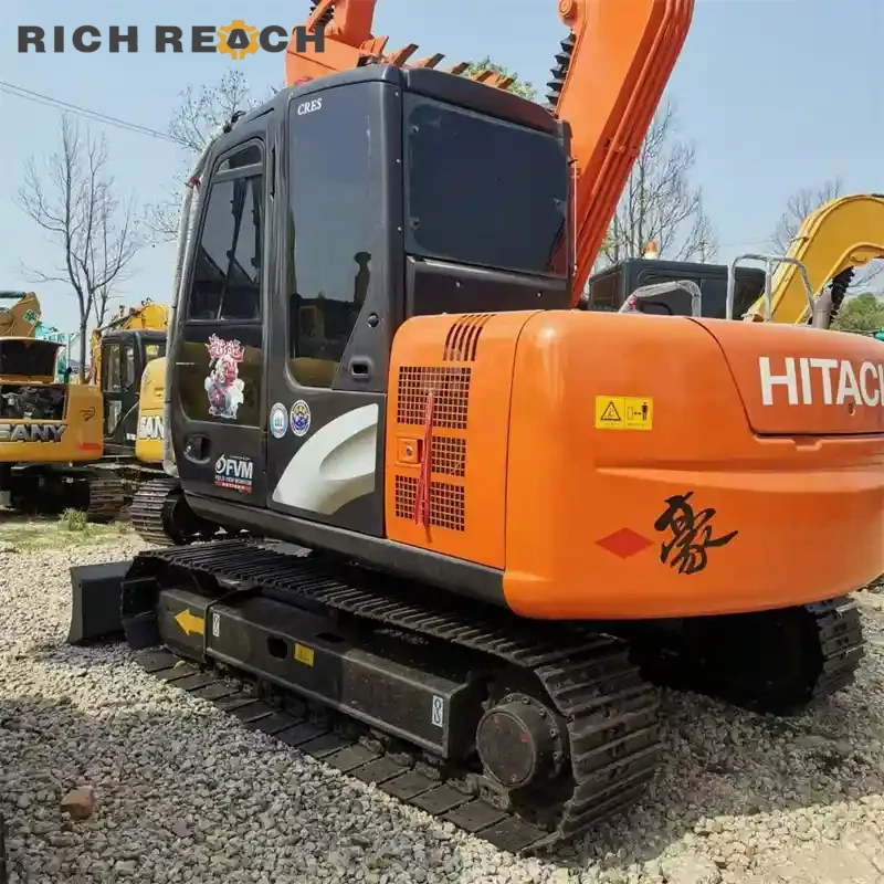 Used Hitachi ZAXIS 70 excavator loading a dump truck, low hours, priced in USD