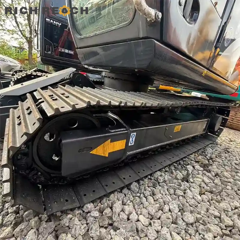 Used Hitachi ZAXIS 70 excavator trenching near a building, low hours, priced in USD