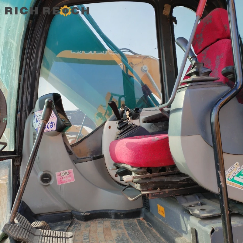 Operator cab with armrest joystick controls of a used Kobelco SK250 excavator, low hours, great value priced in USD