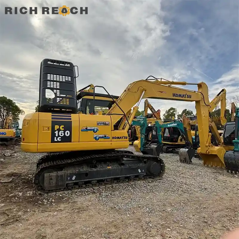 Used Komatsu PC160LC excavator front three-quarter view, LC undercarriage, low hours, more stability, USD sale