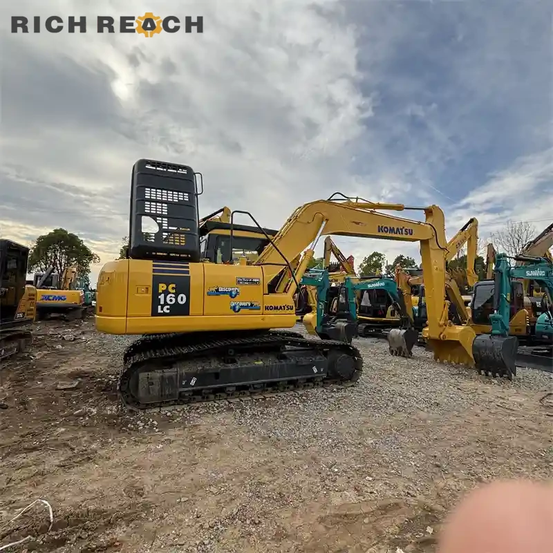 Used Komatsu PC160LC excavator performing stable excavation work, low hours, LC stability, USD price