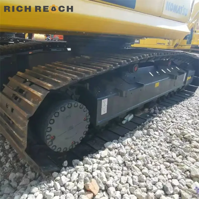 Bottom rollers and track guard of a used Komatsu PC200 crawler excavator