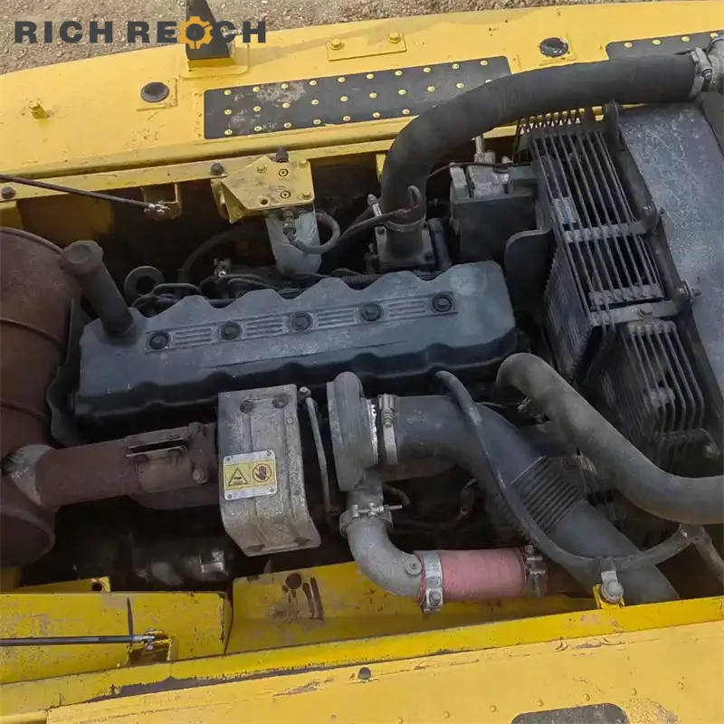 Used Komatsu PC200 excavator grading a parking lot