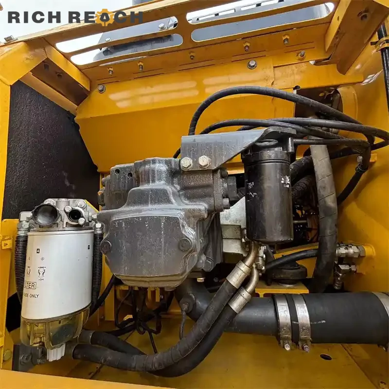 Used Komatsu PC200 excavator lifting a pipe with a sling
