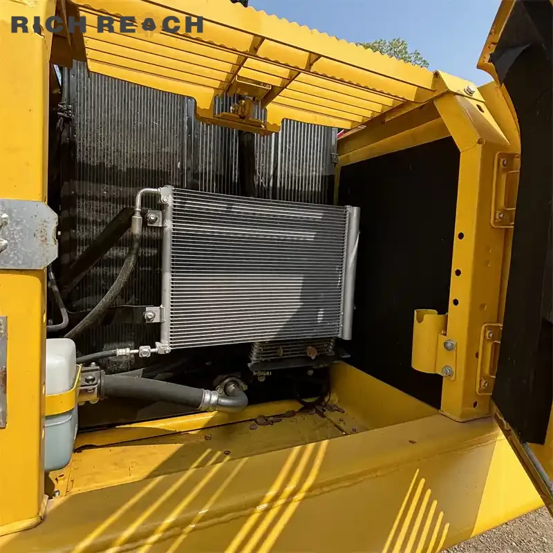 Cab interior and monitor panel of a used Komatsu PC220 excavator for sale