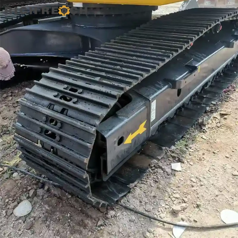 Greasing boom pins on a used Komatsu PC220 excavator for sale