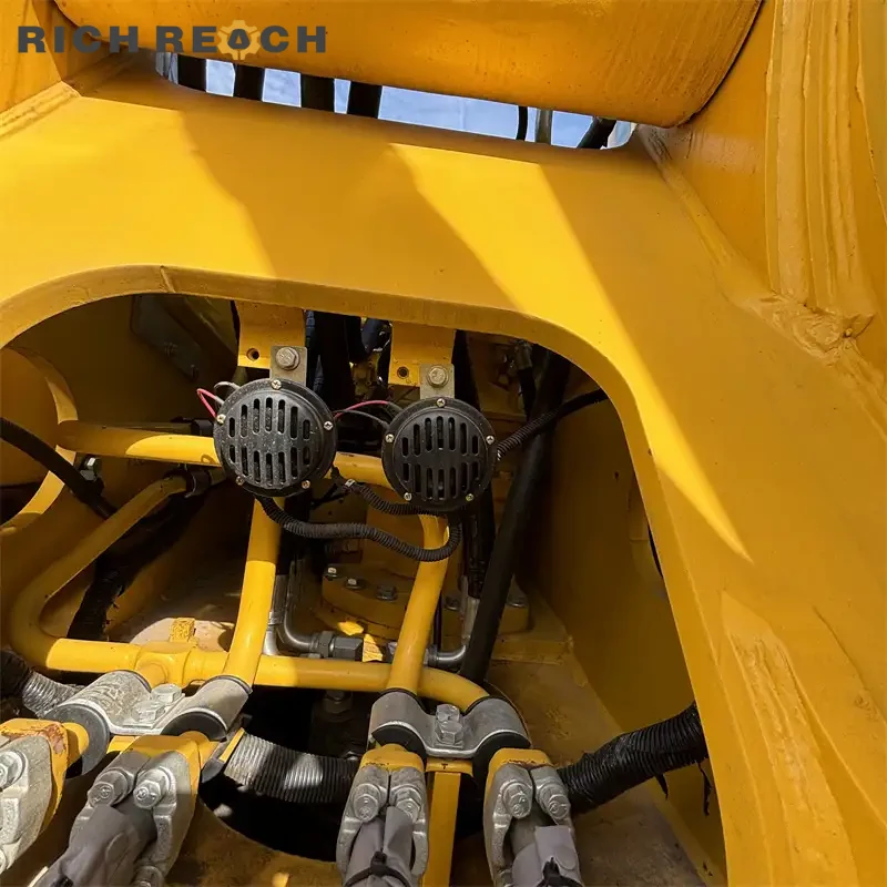 Rear three-quarter view of a used Komatsu PC220 excavator for sale