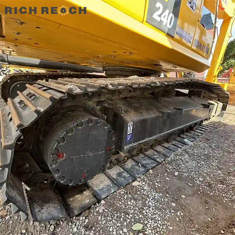 Undercarriage and heavy-duty tracks of a used Komatsu PC240 excavator with low hours and high efficiency