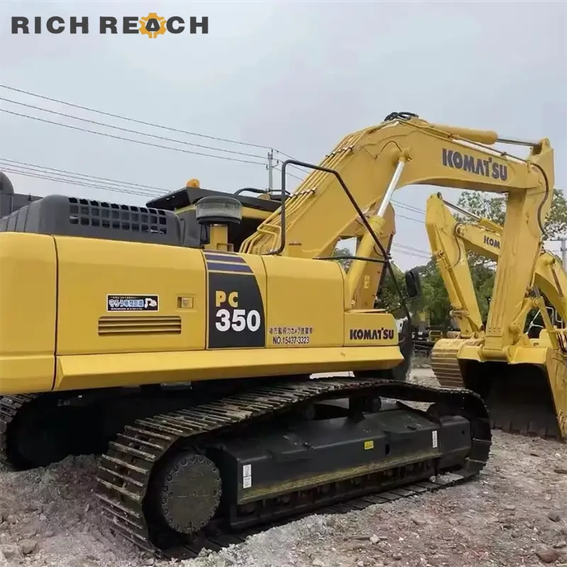 Used Komatsu PC350 excavator loading haul trucks at job site