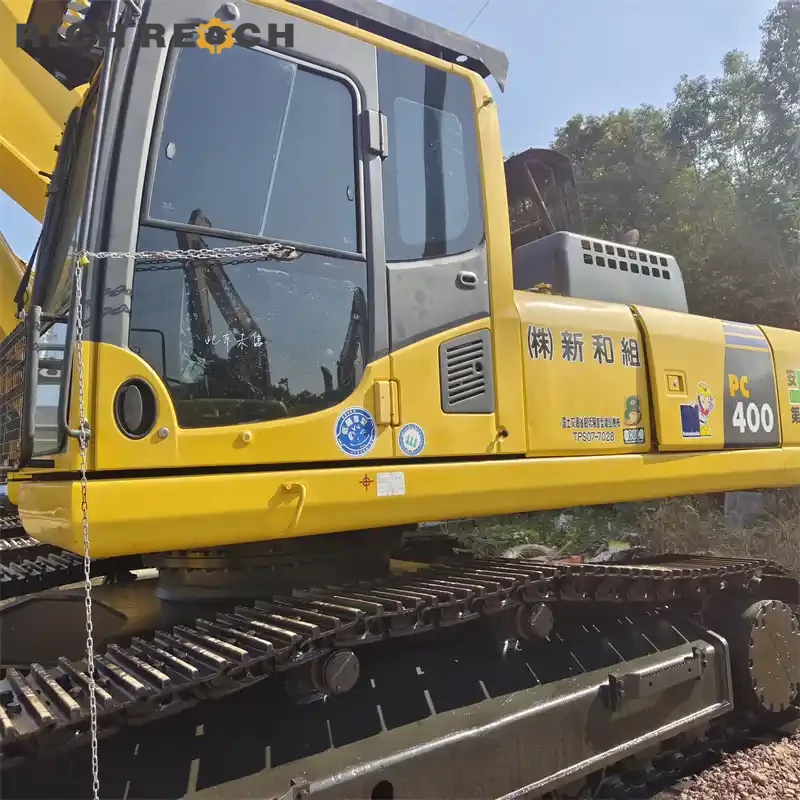 Left side view showing long track frame and idler of a used Komatsu PC400 excavator, low hours, ready to ship