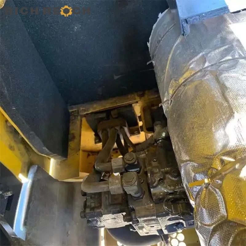 Analog gauges and ignition key of a used Komatsu PC56 excavator – low hours, great value, priced in USD