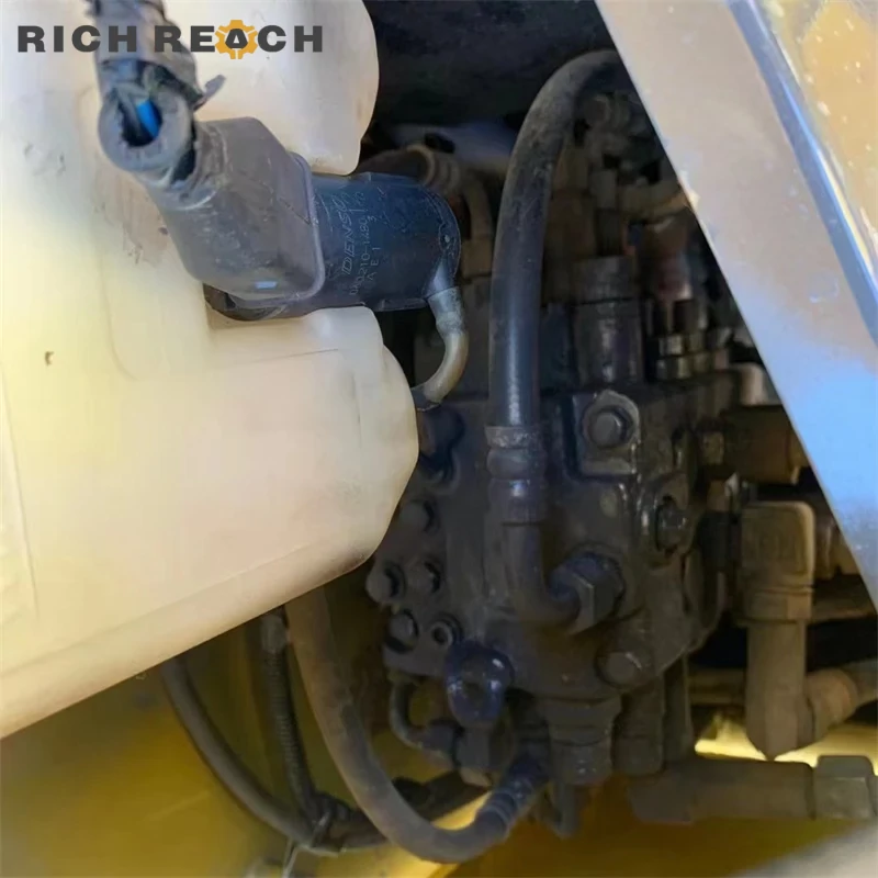 Track chain and roller of a used Komatsu PC56 crawler excavator – inspected undercarriage, great value for sale in USD