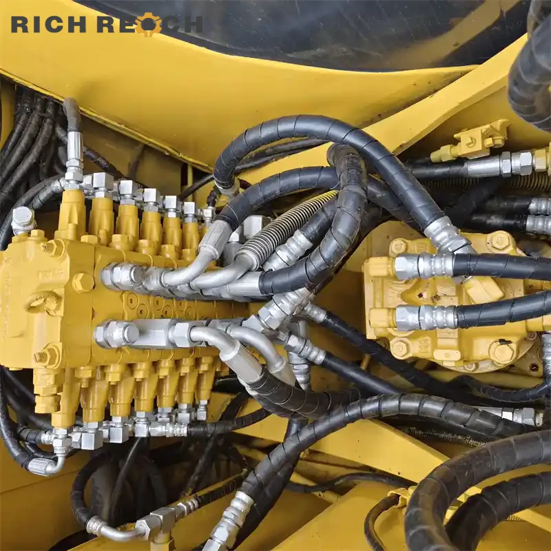 Blade cylinder and hydraulic hoses on a used Komatsu PC60 excavator – well-maintained