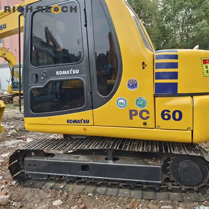 Three-quarter front view of a used Komatsu PC60 excavator – excellent condition, priced in USD