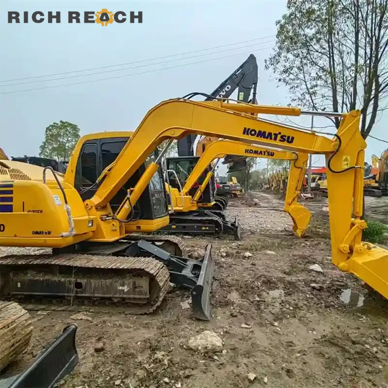 Used Komatsu PC60 excavator trenching near a building – powerful and efficient