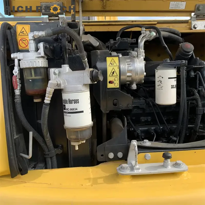 Used Komatsu PC70 mini excavator loading a dump truck