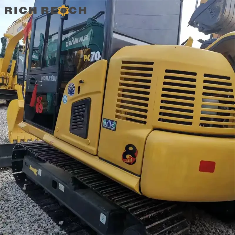 Used Komatsu PC70 mini excavator trenching on a job site