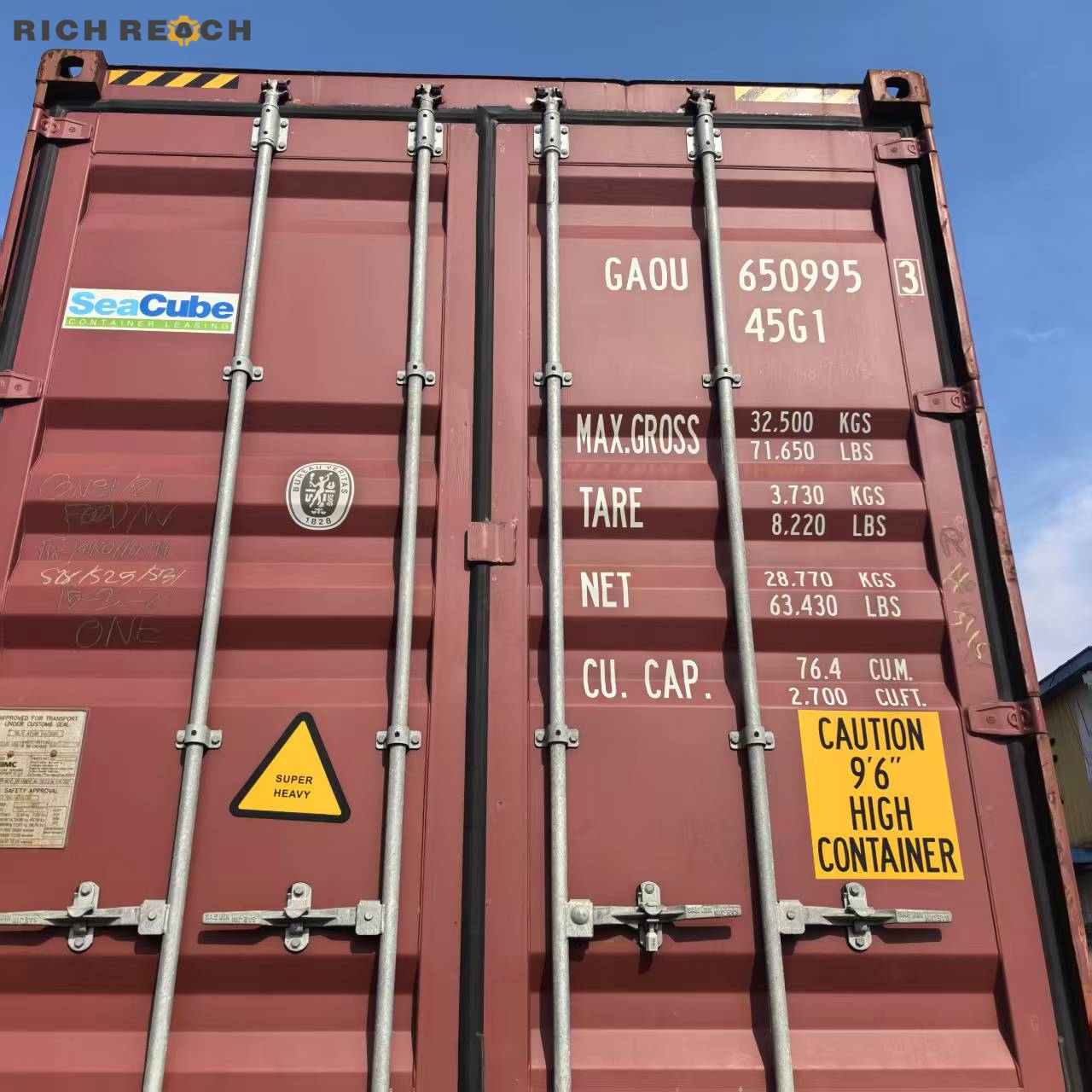 Rear doors of a maroon SeaCube high cube shipping container showing identification codes like GAOU 650995 3, 45G1, and weight specifications under a blue sky.