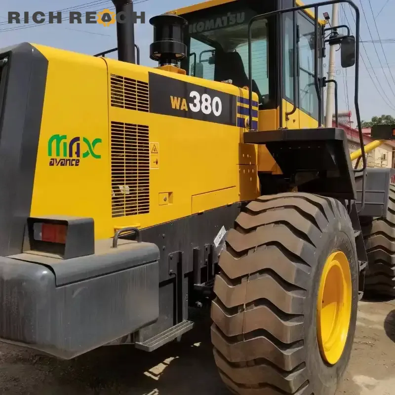 Used Komatsu WA380-6 backhoe loader for sale – front view with loader bucket and backhoe attachment